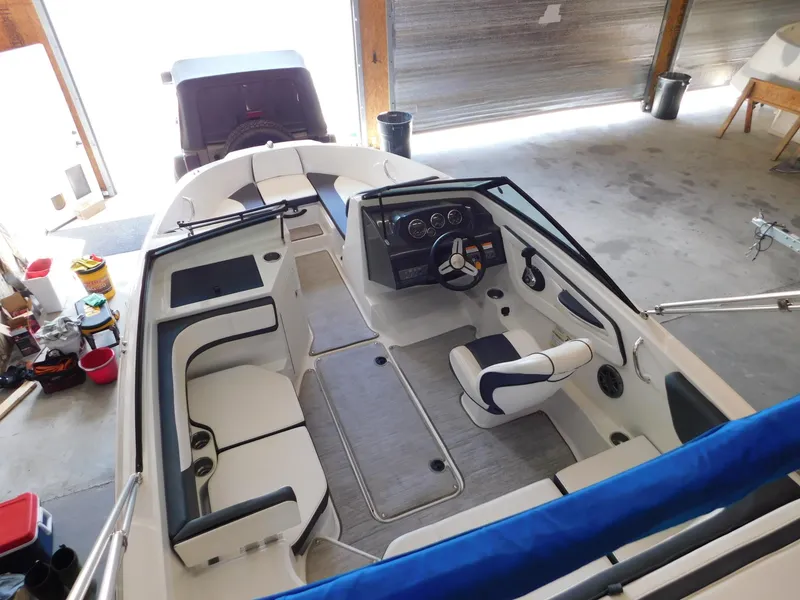 Slide: The Image of Interior view of 2015 Sea Ray 19 SPX boat in a garage setting. - 19