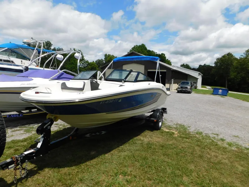 Slide: The Image of 2015 Sea Ray 19 SPX boat on trailer, parked outdoors under cloudy sky. - 20