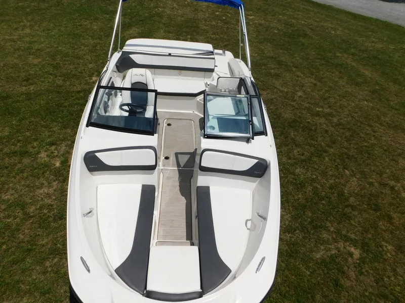 Slide: The Image of 2015 Sea Ray 19 SPX boat, aerial view, white and gray interior, on grass. - 24