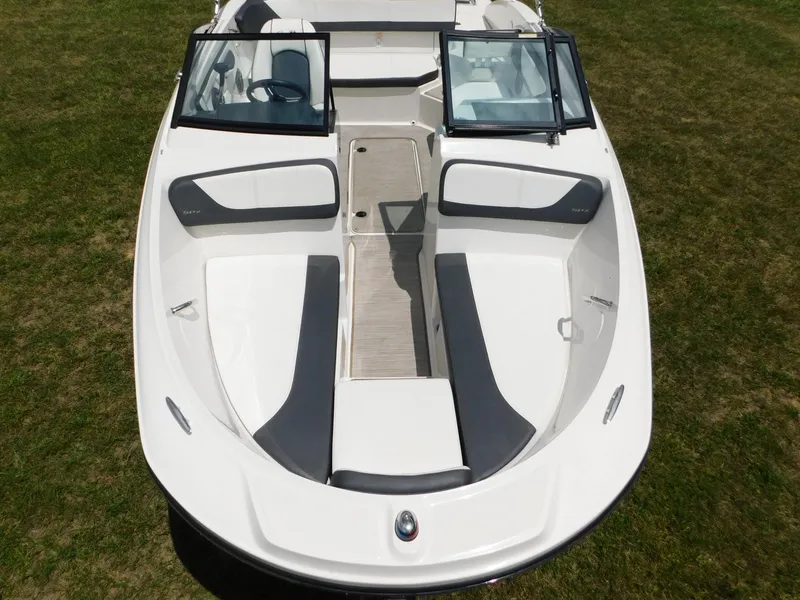 Slide: The Image of 2015 Sea Ray 19 SPX boat with open bow seating on grass. - 25