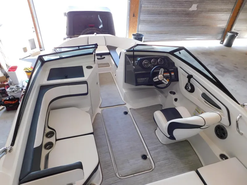 Slide: The Image of 2015 Sea Ray 19 SPX boat interior with seating and steering console. - 5
