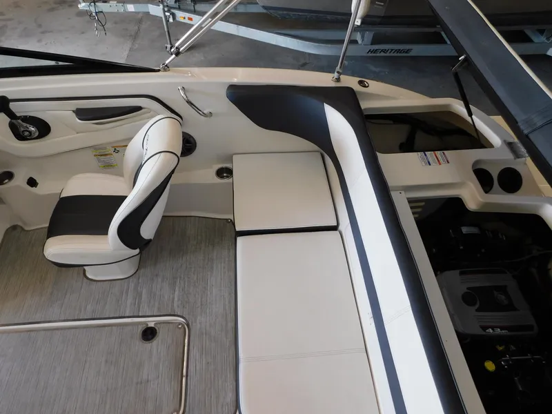 Slide: The Image of 2015 Sea Ray 19 SPX boat interior with white seating and modern design. - 9