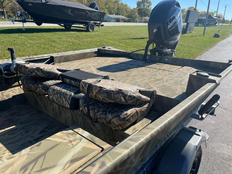 Slide: The Image of 2025 Lowe Roughneck 1760SC boat with camouflage seating and Mercury outboard motor. - 14