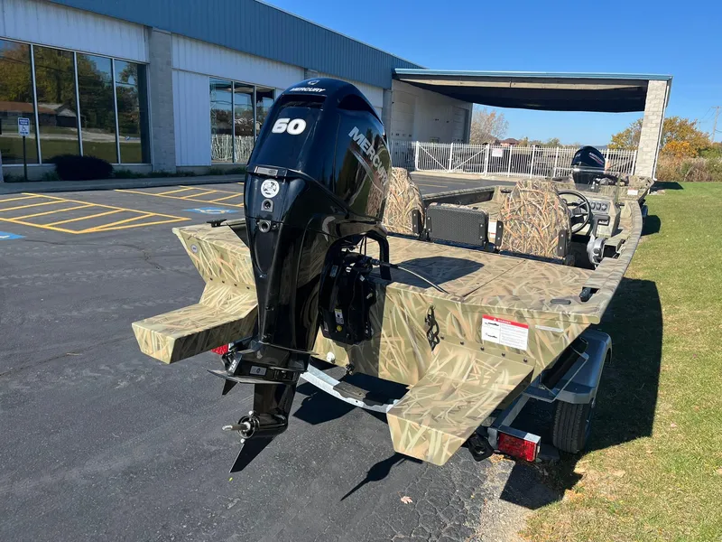 Slide: The Image of 2025 Lowe Roughneck 1760SC boat with camo design and Mercury 50 outboard motor. - 2