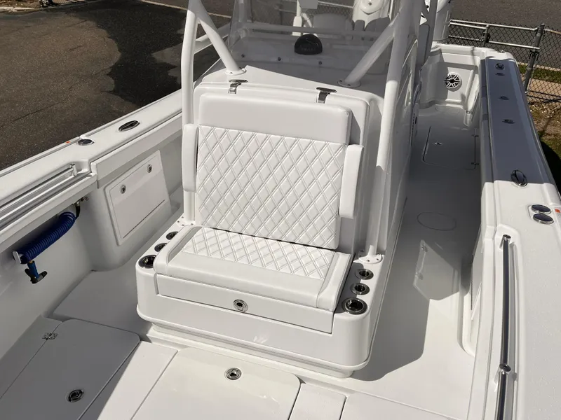 Slide: The Image of 2025 Yellowfin 32 boat interior with white cushioned seating and sleek design. - 11
