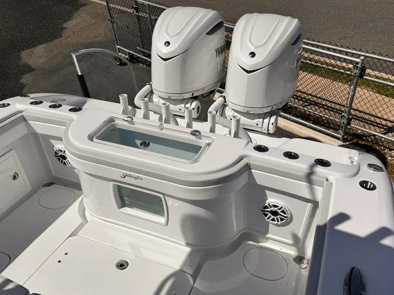 Slide: The Image of 2025 Yellowfin 32 boat with dual outboard engines and fishing rod holders. - 13