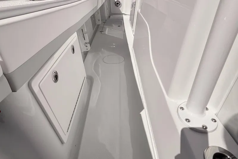 Slide: The Image of 2025 Yellowfin 32 boat interior, featuring sleek white deck and storage compartments. - 17