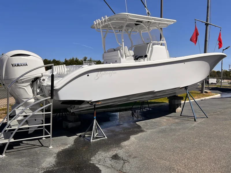 Slide: The Image of 2025 Yellowfin 32 boat with Yamaha engines on display outdoors. - 2