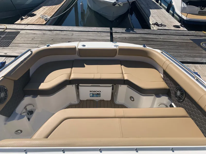 Slide: The Image of 2024 Sea Ray SDX 250 Outboard boat interior with tan seating at a dock. - 18