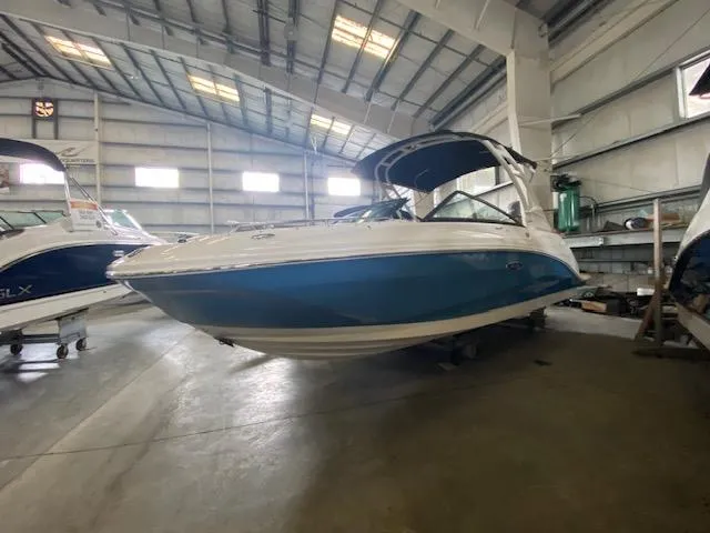 Slide: The Image of 2024 Sea Ray SDX 250 Outboard boat in a spacious indoor showroom. - 3