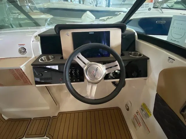 Slide: The Image of 2024 Sea Ray SDX 250 Outboard helm with modern steering and controls. - 5