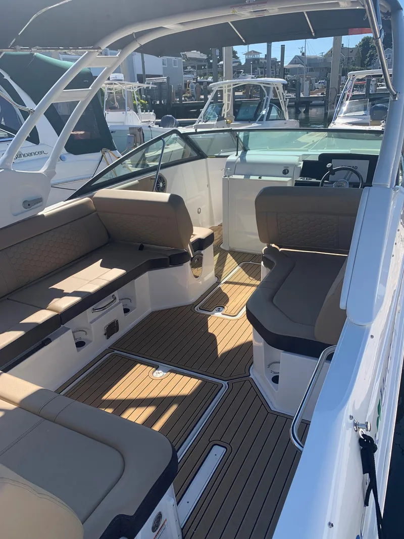 Slide: The Image of 2024 Sea Ray SDX 250 Outboard boat interior with spacious seating and sleek design. - 7