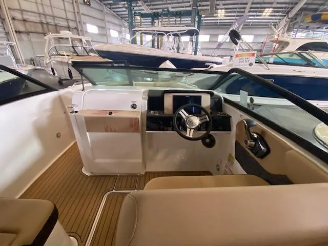 Slide: The Image of 2024 Sea Ray SDX 250 Outboard boat interior with steering wheel and dashboard. - 8