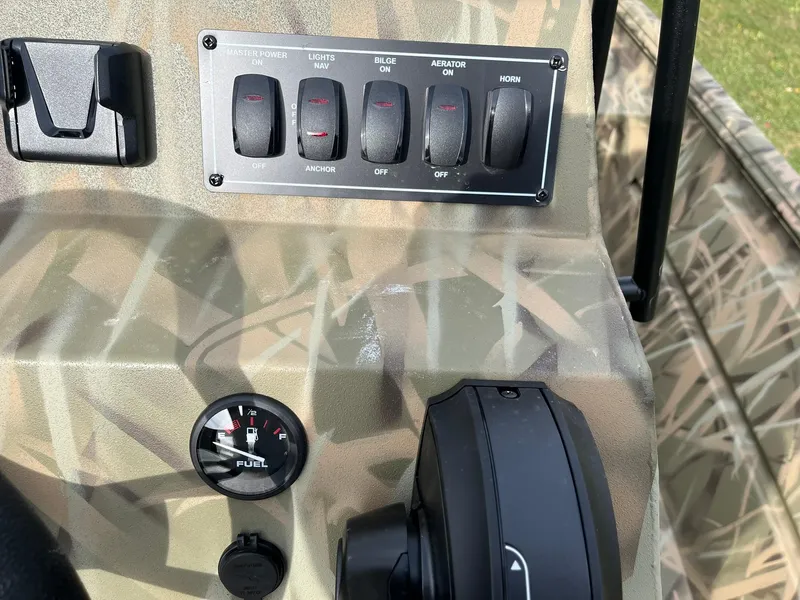 Slide: The Image of Control panel of 2025 Lowe Roughneck 1860 Tunnel Jet boat with switches and fuel gauge. - 13