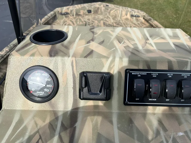 Slide: The Image of Control panel of 2025 Lowe Roughneck 1860 Tunnel Jet boat with camouflage design. - 14