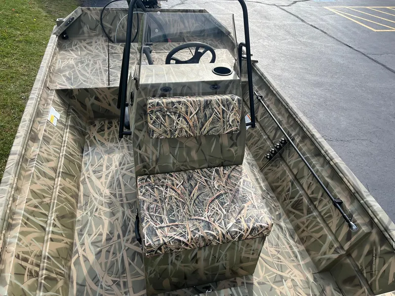 Slide: The Image of 2025 Lowe Roughneck 1860 Tunnel Jet boat with camouflage interior design. - 15