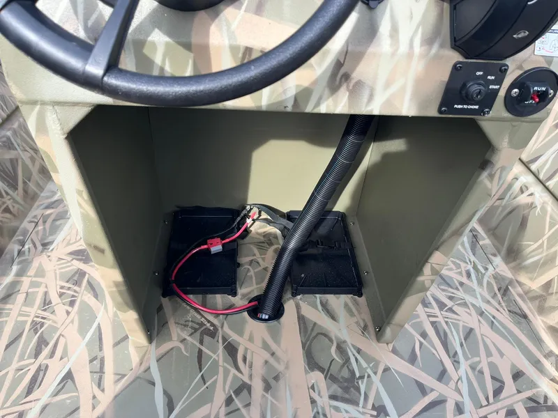 Slide: The Image of 2025 Lowe Roughneck 1860 Tunnel Jet boat console with wiring and camouflage design. - 18