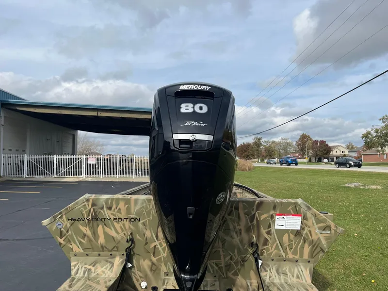 Slide: The Image of 2025 Lowe Roughneck 1860 Tunnel Jet boat with Mercury 80 HP engine, outdoors. - 2