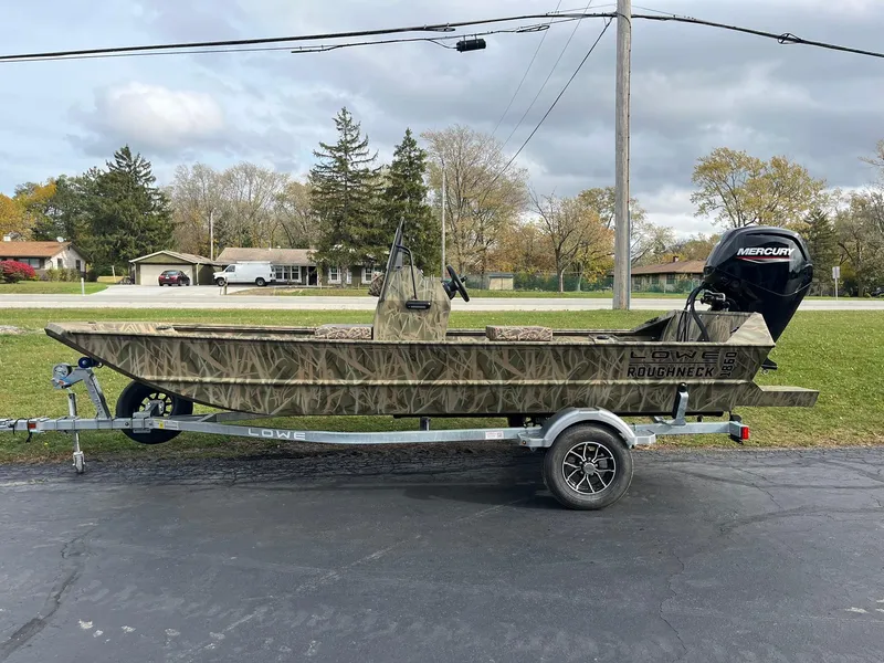 Slide: The Image of 2025 Lowe Roughneck 1860 Tunnel Jet boat on trailer, camo design, Mercury engine. - 3