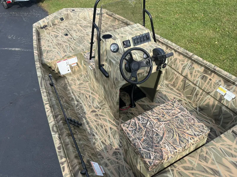 Slide: The Image of 2025 Lowe Roughneck 1860 Tunnel Jet boat with camouflage design and steering console. - 5