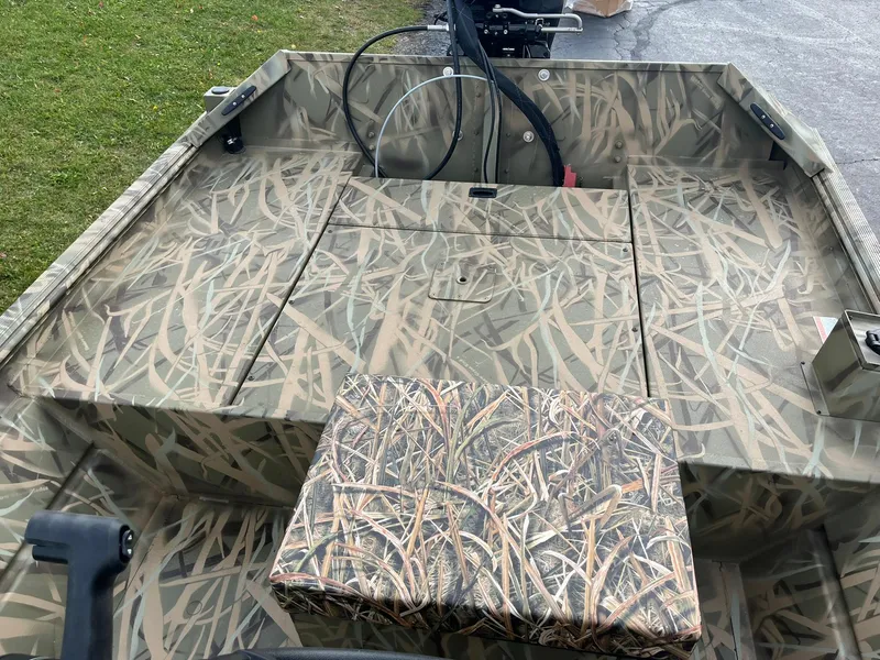 Slide: The Image of 2025 Lowe Roughneck 1860 Tunnel Jet boat with camouflage interior design. - 8