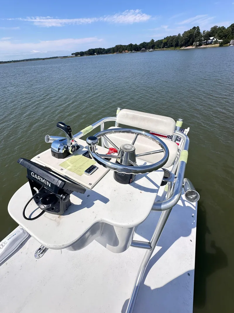 Slide: The Image of 1995 Mako 221 B Classic Center Console boat on calm lake waters. - 10