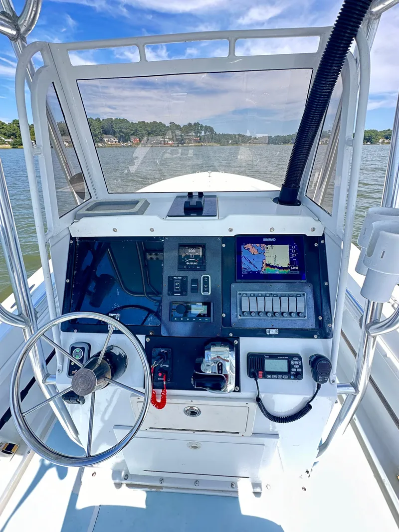 Slide: The Image of 1995 Mako 221 B Classic Center Console boat dashboard with steering wheel and navigation equipment. - 12