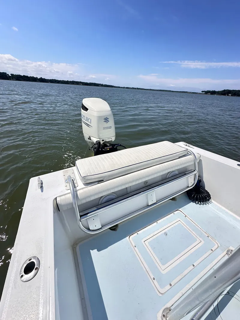 Slide: The Image of 1995 Mako 221 B Classic Center Console boat on calm water. - 14