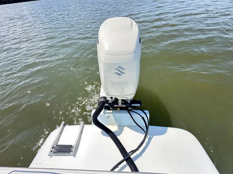 Slide: The Image of 1995 Mako 221 B Classic Center Console boat with outboard motor on water. - 19