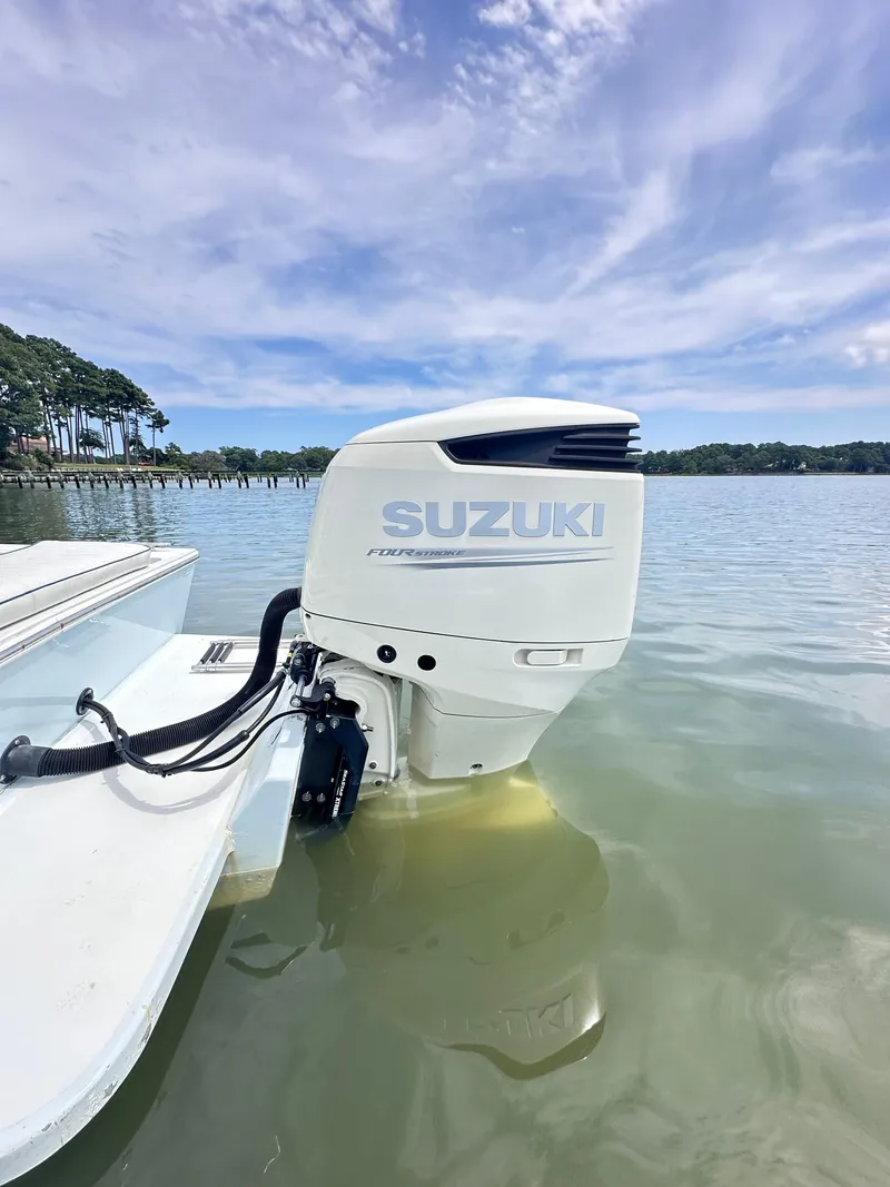 Slide: The Image of 1995 Mako 221 B boat with Suzuki outboard motor on calm water. - 20