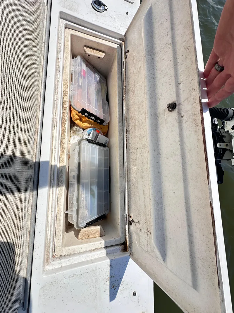 Slide: The Image of Open storage compartment on 1995 Mako 221 B Classic Center Console boat. - 22