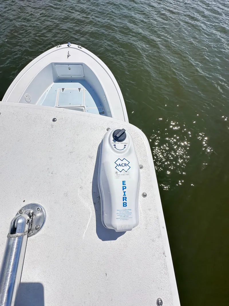 Slide: The Image of 1995 Mako 221 B Classic Center Console with EPIRB on deck, floating on water. - 23