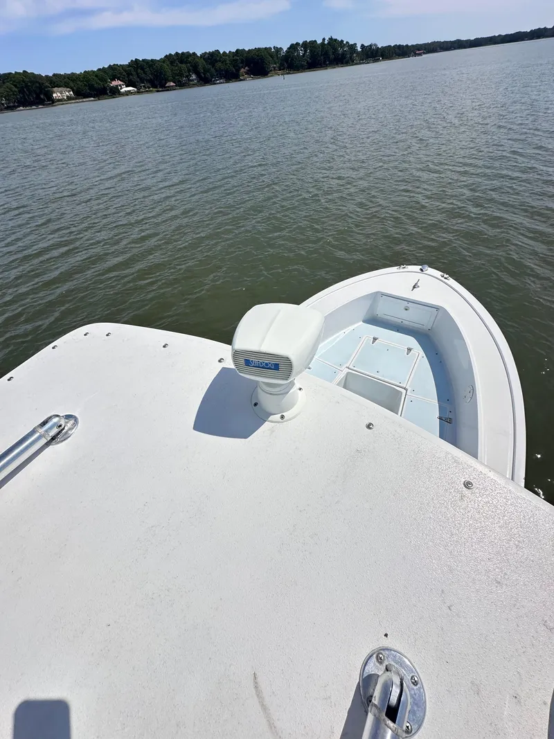 Slide: The Image of 1995 Mako 221 B Classic Center Console boat on calm lake waters. - 24