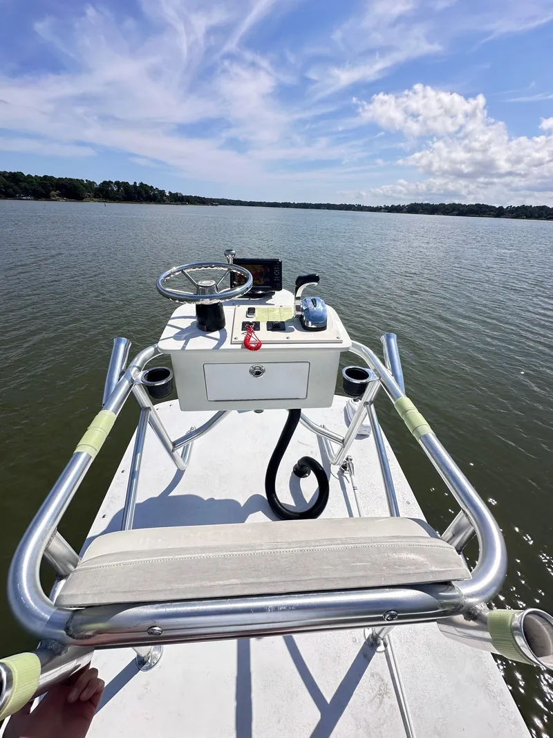 Slide: The Image of 1995 Mako 221 B Classic Center Console boat on calm water under blue sky. - 8