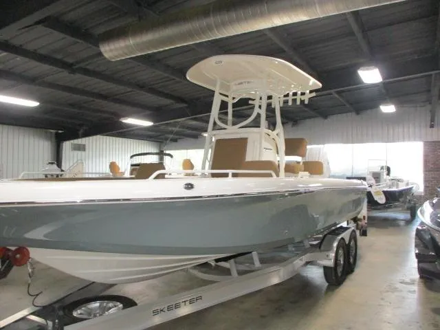 The Image of 2025 Skeeter SX2550 boat on trailer in indoor showroom. - 1