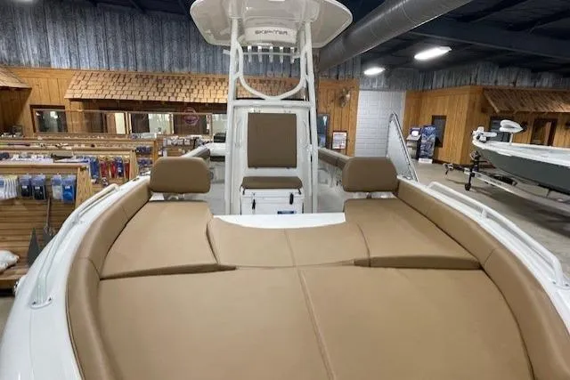 Slide: The Image of 2025 Skeeter SX2550 boat with tan seating in a showroom. - 13