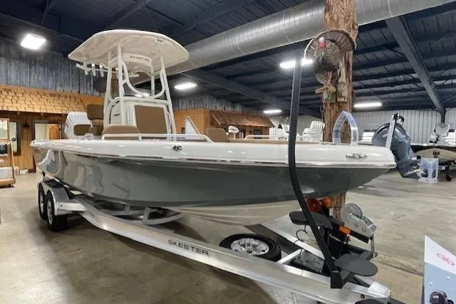 Slide: The Image of 2025 Skeeter SX2550 boat on trailer in indoor showroom. - 14