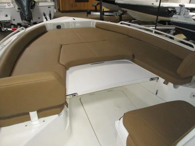 Slide: The Image of 2025 Skeeter SX2550 boat interior with brown cushioned seating and white deck. - 2