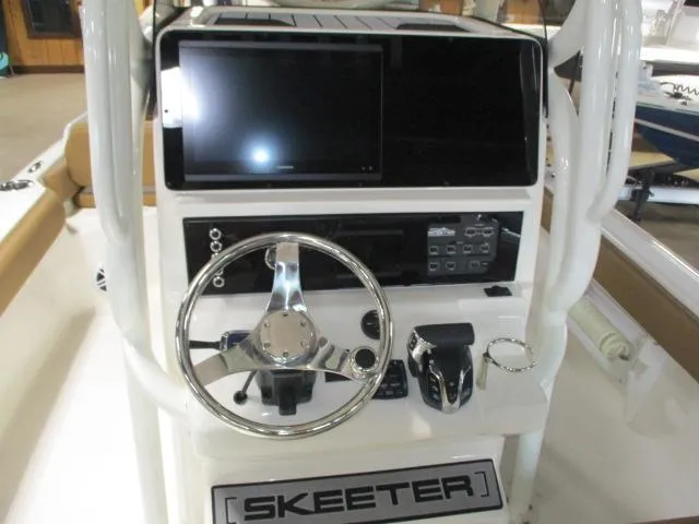 Slide: The Image of 2025 Skeeter SX2550 boat console with steering wheel and electronic controls. - 5