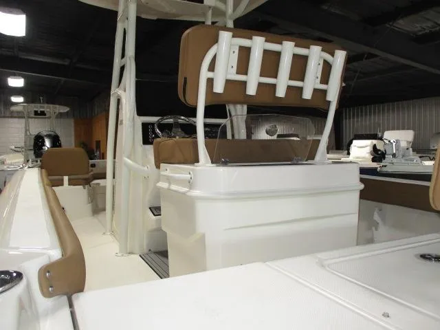 Slide: The Image of 2025 Skeeter SX2550 boat interior with seating and rod holders in a showroom. - 7