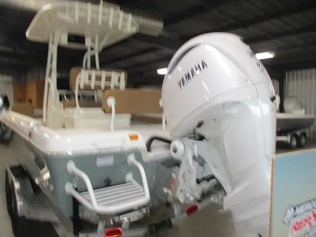 Slide: The Image of 2025 Skeeter SX2550 boat with Yamaha outboard motor in a storage facility. - 8