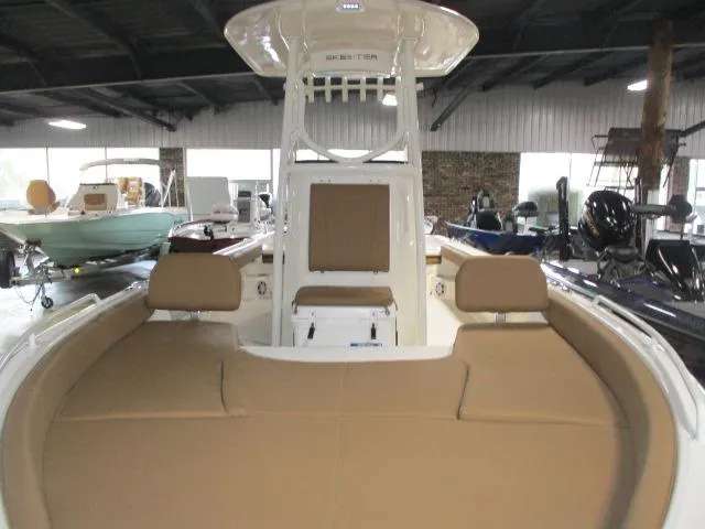Slide: The Image of 2025 Skeeter SX2550 boat interior with tan seating, displayed in a showroom. - 9