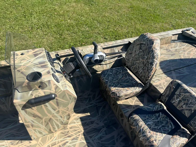 Slide: The Image of 2025 Lowe Roughneck 2070 SC boat with camouflage seats and steering console. - 13