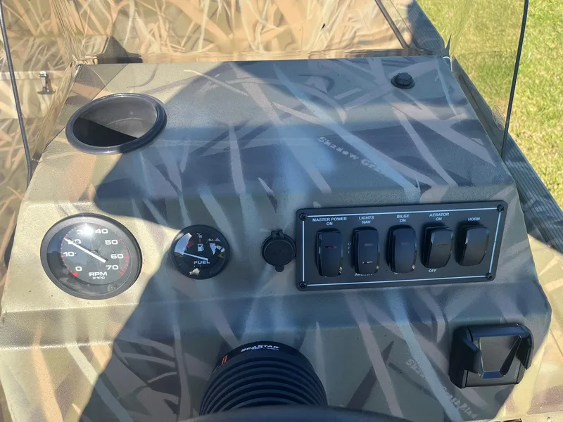 Slide: The Image of Control panel of 2025 Lowe Roughneck 2070 SC boat with gauges and switches. - 16