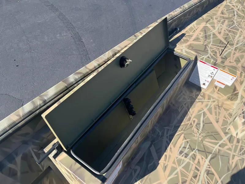 Slide: The Image of 2025 Lowe Roughneck 2070 SC boat storage compartment with camouflage design. - 18