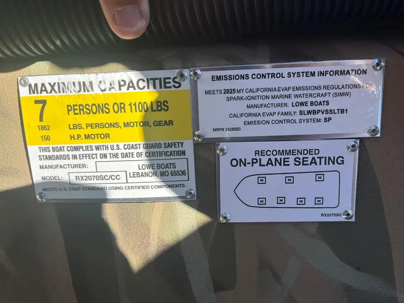 Slide: The Image of Capacity and emissions labels on 2025 Lowe Roughneck 2070 SC boat. - 23