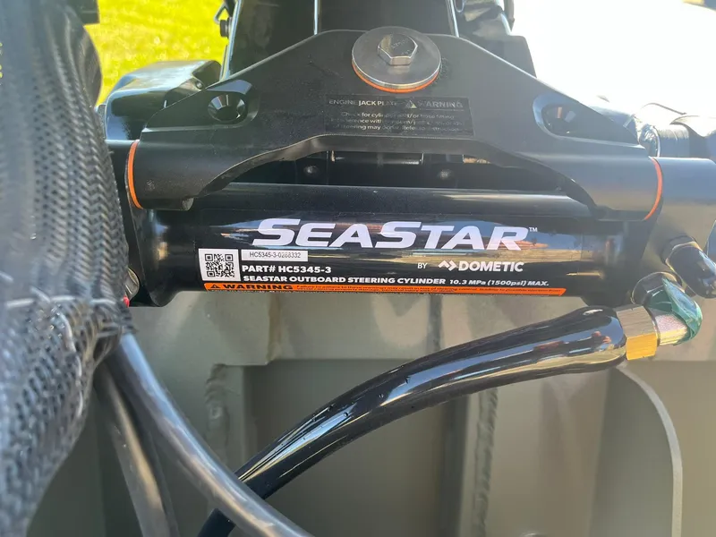 Slide: The Image of SeaStar outboard steering cylinder on 2025 Lowe Roughneck 2070 SC boat. - 24
