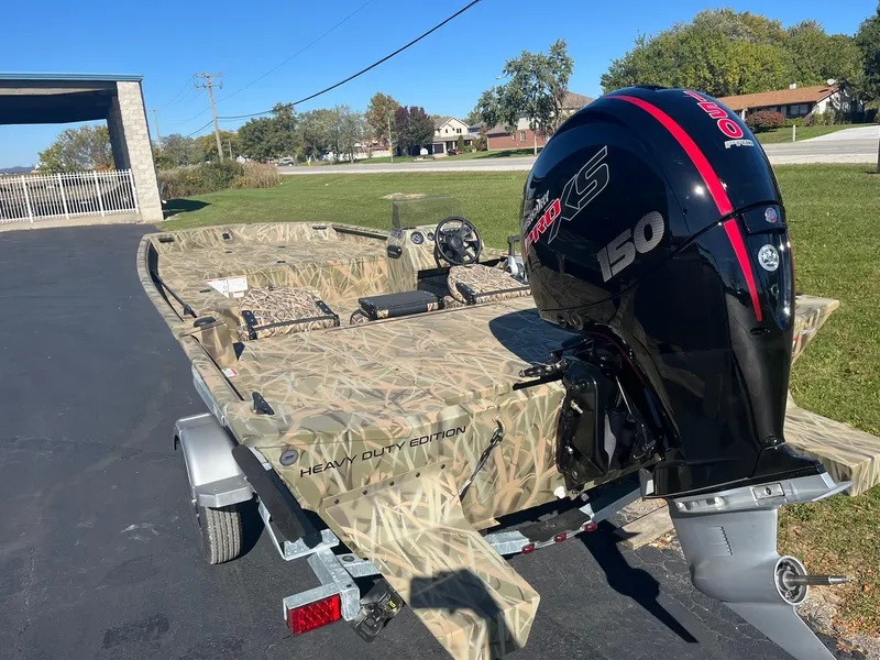 Slide: The Image of 2025 Lowe Roughneck 2070 SC boat with camo design and powerful outboard motor. - 5