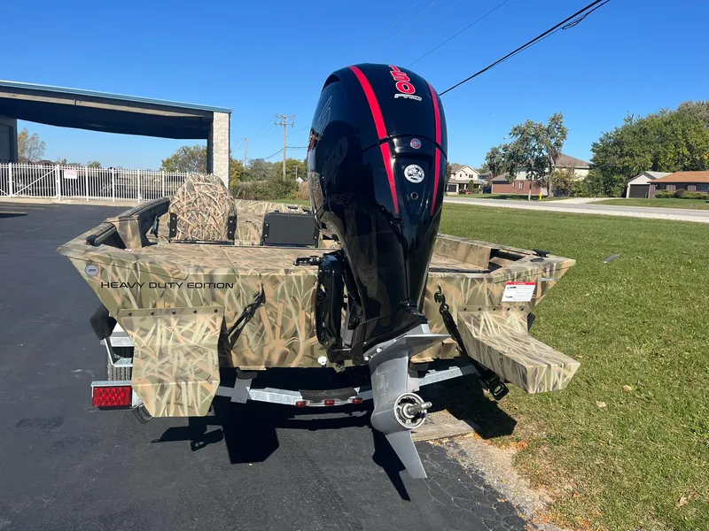 Slide: The Image of 2025 Lowe Roughneck 2070 SC boat with camo design and powerful outboard motor. - 6