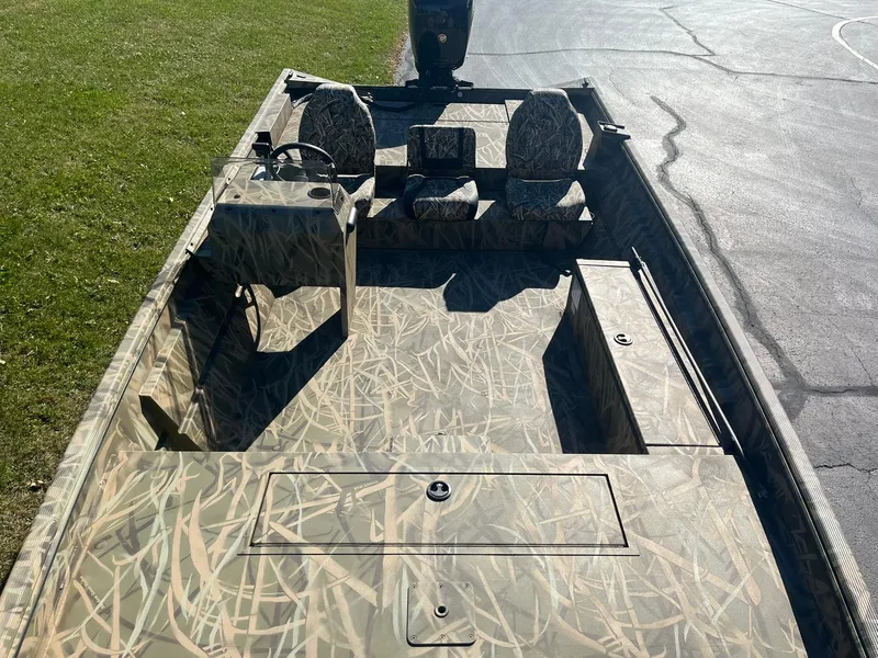 Slide: The Image of 2025 Lowe Roughneck 2070 SC boat with camouflage design on a sunny day. - 9